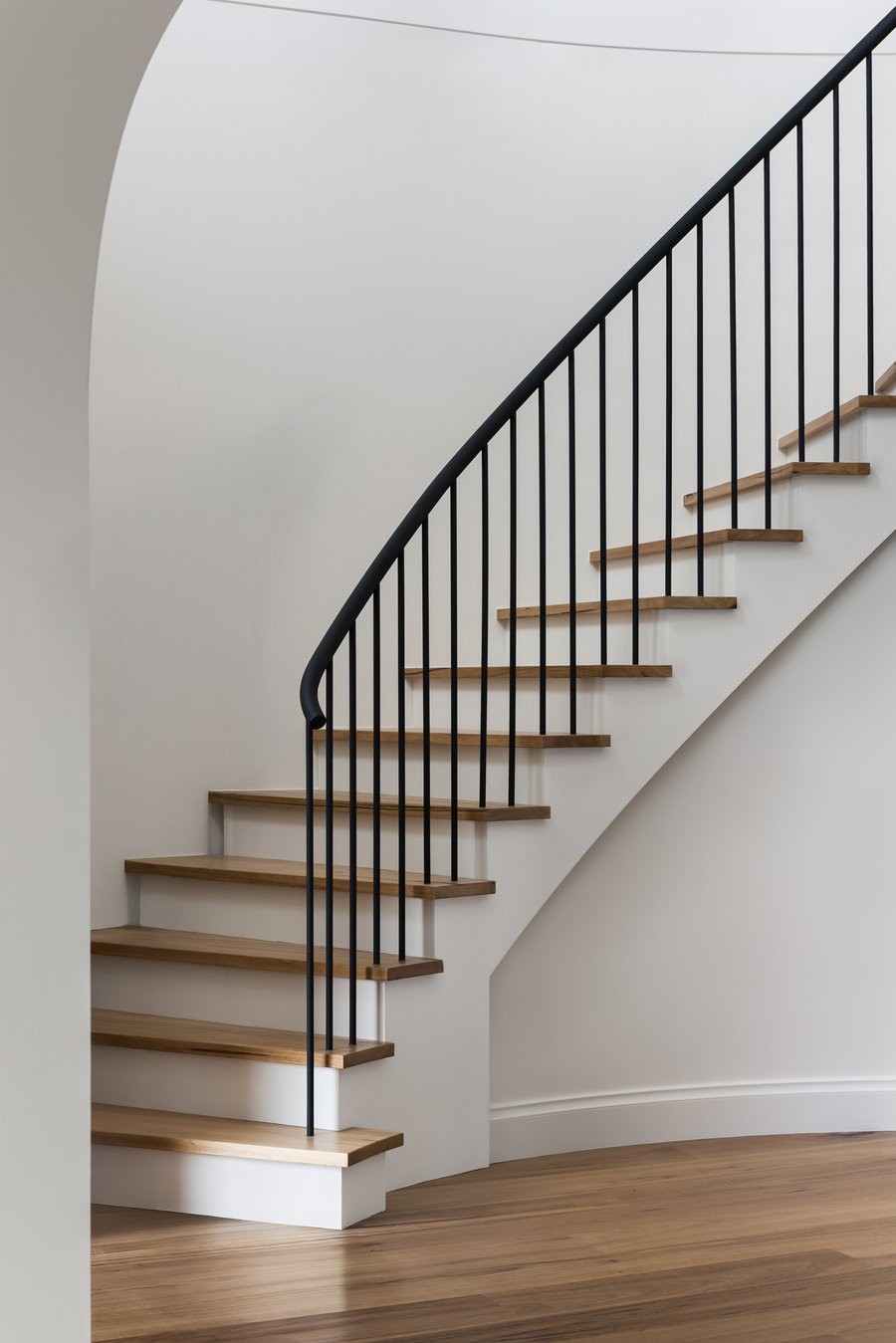 Varcon Group custom home, curved staircase with timber treads and steel balustrade, Mont Albert