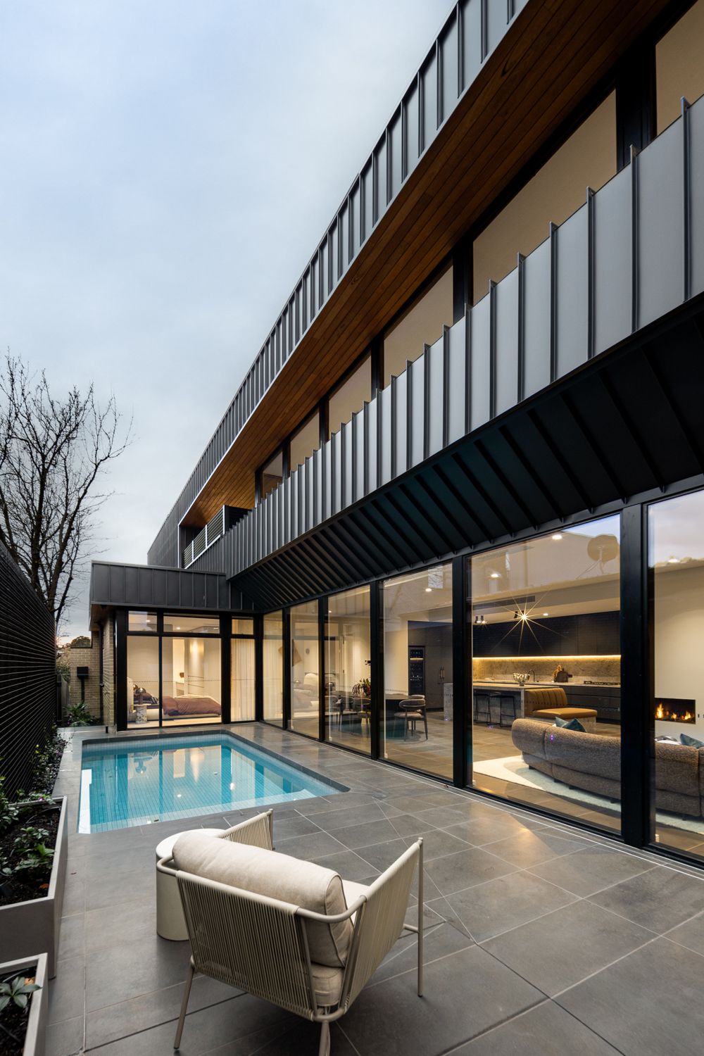 Plungie Max pool and grey paved terrace beneath the cantilevered upper level at The Ora