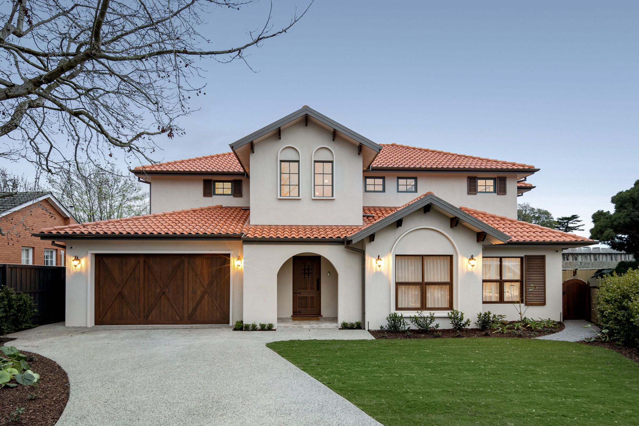 Mont Albert custom home, modern Tuscan facade with terracotta roof and render finish