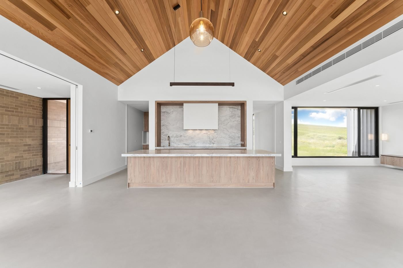 Central kitchen and dining pavilion at Musk with a timber-lined cathedral ceiling and glazed gable end