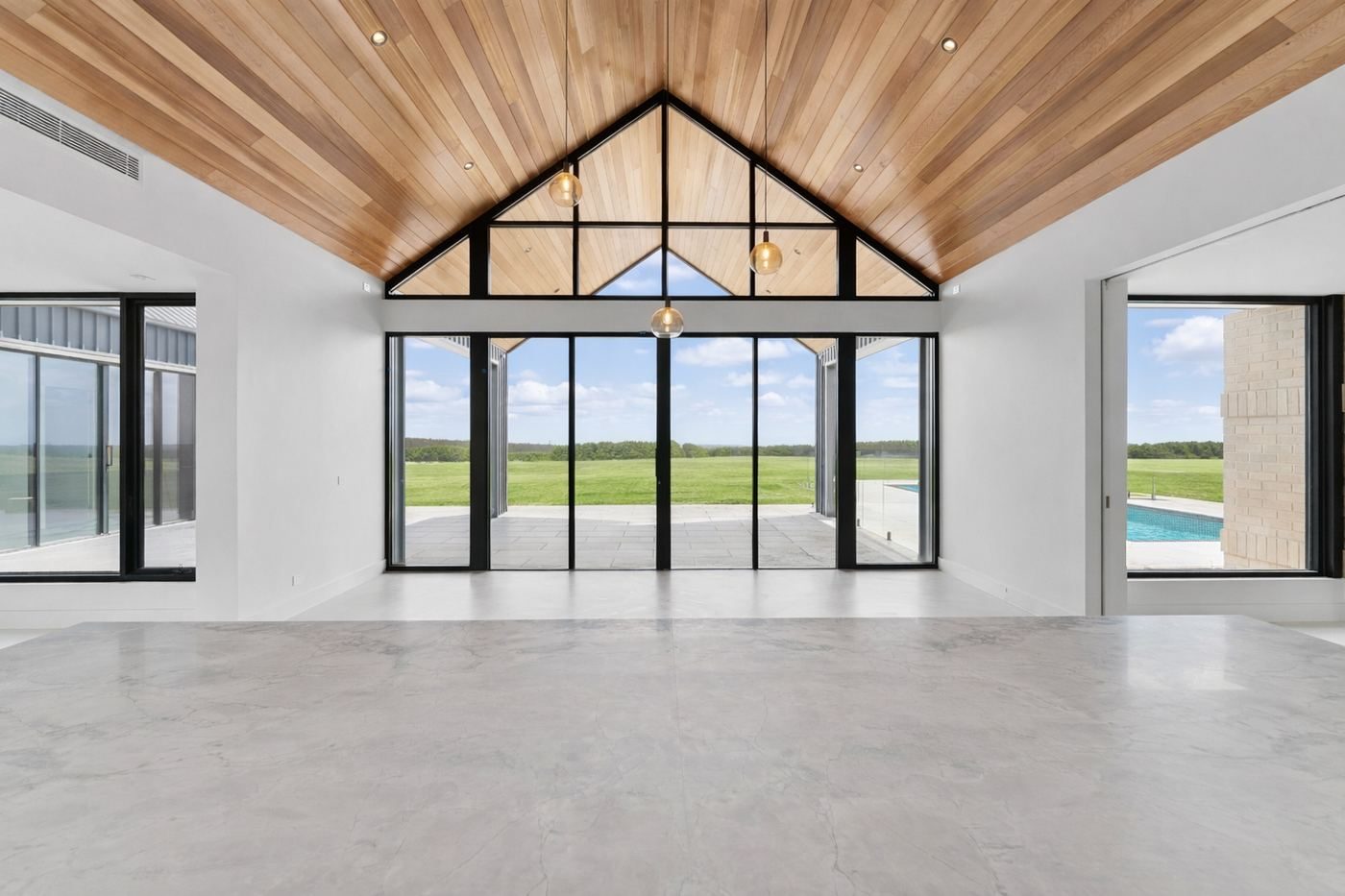 Interior of Musk showing the contrast between timber ceiling, brick feature wall and polished concrete floor